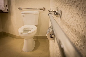 disabled toilet bathroom with grab bars in white interior design hotel