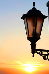 Fototapeta na wymiar sunset on the beach, old lantern