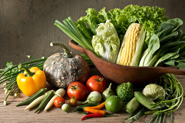 Still life photography : various vegetable in wood bowl and on old wood with grunge background