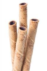 rolled wafer filled with chocolate fudge on white background