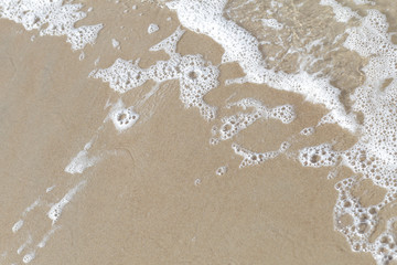 Sea foam on sand