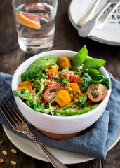 Quinoa salad with tomatoes, avocado, grapefruit, pine nuts and mint served in a bowl