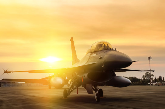 f16 falcon fighter jet parked  on sunset  background 