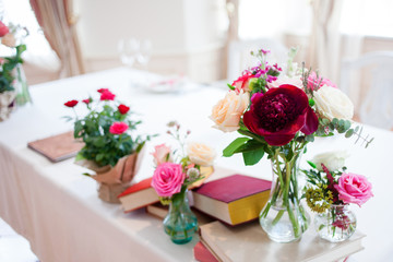 Obraz na płótnie Canvas Wedding banquet, small restaurant floral, decor in red, informal style.