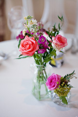 Obraz na płótnie Canvas Wedding banquet, small restaurant floral, decor in red, informal style.