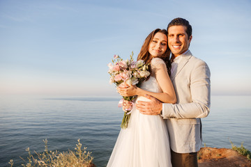 Happy just married young wedding couple celebrating