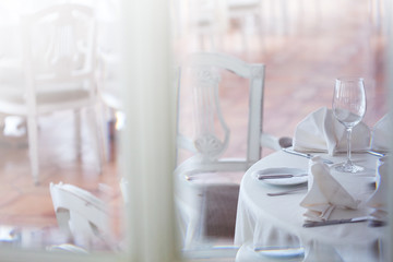 View through the glass at restaurant. Interior in white tones