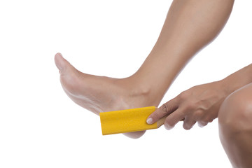 Woman scrubbing her heel with foot rasp isolated on white background.