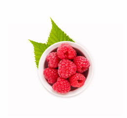 Raspberries in a white ceramic bowl. Ripe and tasty raspberries isolated on white background. Top view