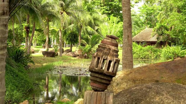 In green solar jungles of southeast Asia. Resort area with palm trees. 4K.