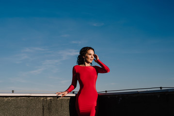 young beautiful brunette woman in a red dress