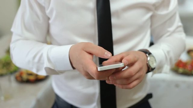 Man In White Shirt Uses Smartphone, Close Up