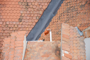 Roof orange shingles with chimney