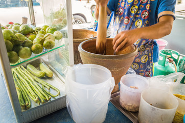 Thailand famous street food, action of cooking papaya salad or thai people call "Som tum"