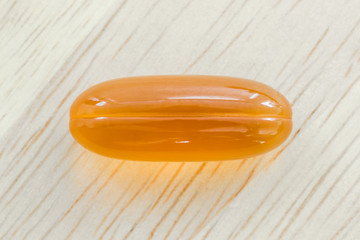 Close up gel capsule on wooden table