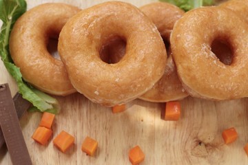 Donut topped sugar delicious on wood background.