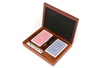 dice and playing cards in a box on white background