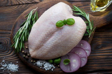 Above view of raw fresh chicken breast with seasonings