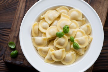Above view of ravioli in bouillon, close-up, studio shot
