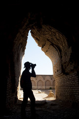 Adventurer photographer in the old destroyed mosque