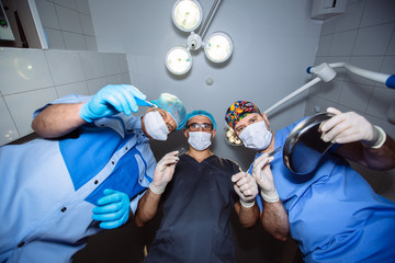 Below view of surgeons holding medical instruments in hands. Concept a healthy