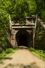 Fototapeta na wymiar Bike Trail Tunnel / A bike trail passing through a former railroad tunnel.