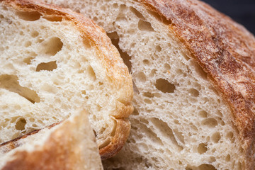 Rustic bread on wood table. Dark wooden background
