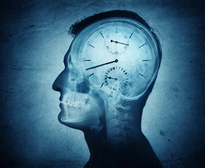 Human head silhouette with clock.