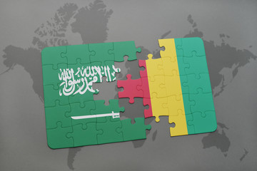puzzle with the national flag of saudi arabia and guinea on a world map background.