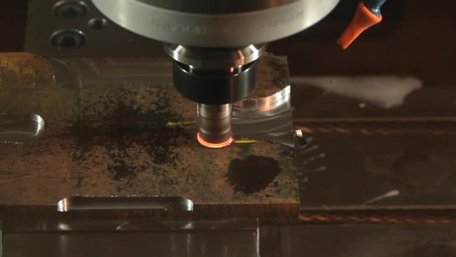 cnc machine milling steel with sparks flying and metal melting