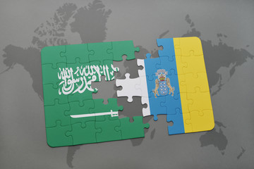 puzzle with the national flag of saudi arabia and canary islands on a world map background.