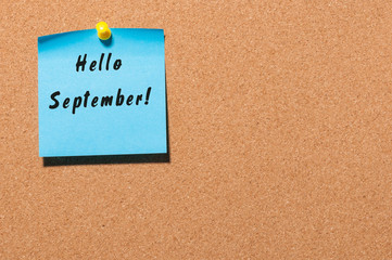 Hello September wrote at paper pinned to notice board. Autumn time concept