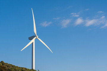 Wind turbine on blue sky