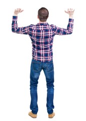 Back view of handsome man in checkered shirt keep on hand.   Standing young guy in jeans. Rear view...