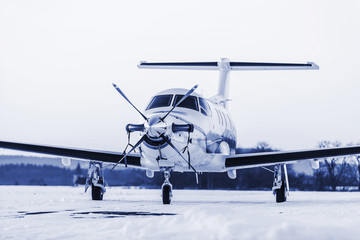 Single turboprop aircraft on winter runway. Pribram airport.