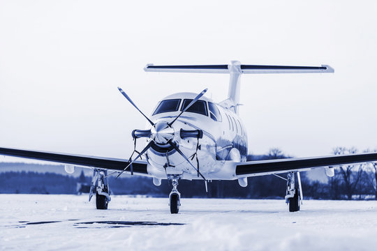 Single turboprop aircraft on winter runway. Pribram airport.
