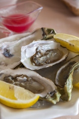 fresh oysters on a plate with lemon