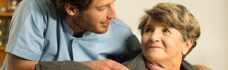 Covering elderly woman with blanket