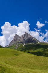 Fototapeta na wymiar Berggipfel im schönen Bregenzer Wald mit toller Wolkenstimmung und Schattenspielen
