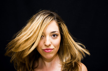 Portrait of Beautiful Young Woman Shaking Her Hair