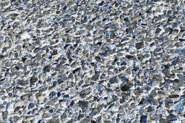 Rough uneven gray stone background old curve sprinkled gravel