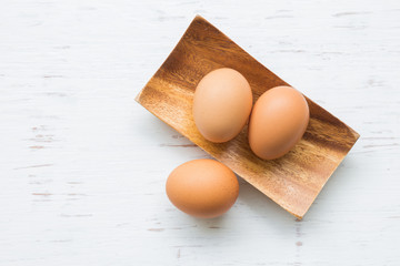Eggs on white rustic wooden background