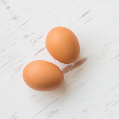 Eggs on white rustic wooden background