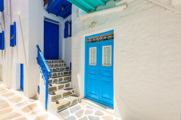 Blue door and windows of typical house on street of beautiful Mykonos town, Cyclades islands, Greece