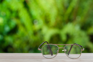 Old eyeglasses on wooden table.