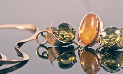 Old gold earrings with green stones and a ring with amber