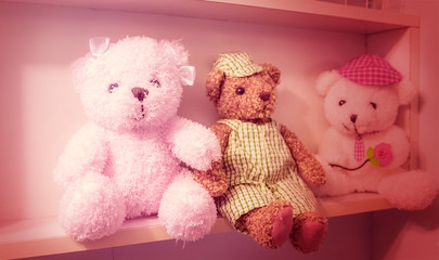 Teddy bear on the shelves, the effect of pink.