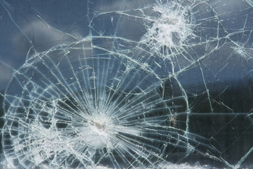 Window with broken glass, reflecting the sky
