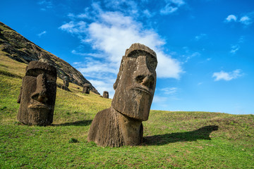 Moai statues in the Rano Raraku Volcano in Easter Island, Chile - obrazy, fototapety, plakaty
