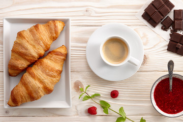 Espresso coffee with croissants and jam